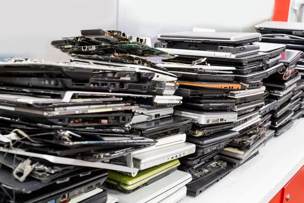 Laptops Titan-8 IT Asset Management Software Stack of old, disassembled laptops on table for IT Asset Management Software through Titan-8