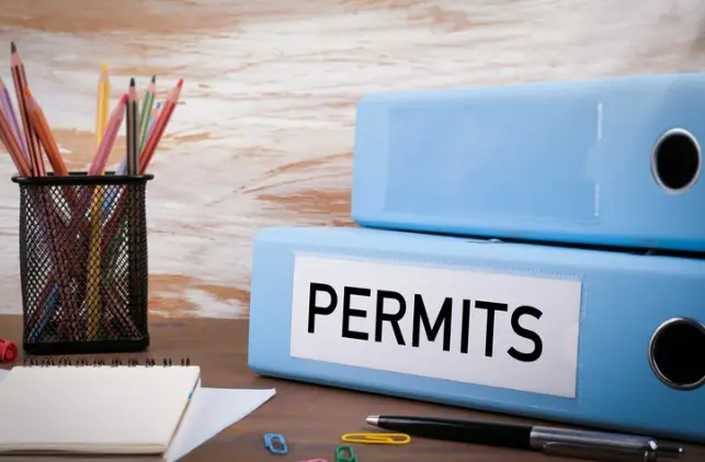 Hotel permit tracking binders representing the volume of permits and licenses RenewAlert tracks for hotel management companies