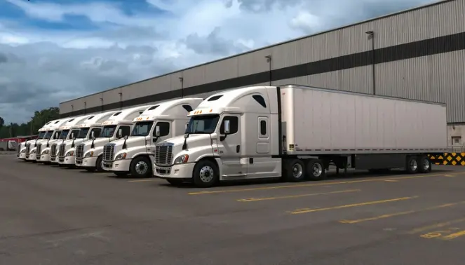 Fleet of trucks at loading dock representing DOT compliance tracking during fleet growth with RenewAlert