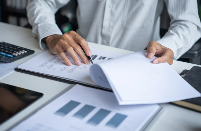 Hotel operations manager reviewing vendor contract data for portfolio-wide auditing with RenewAlert